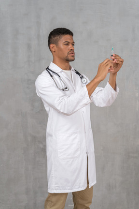 Male doctor preparing a syringe