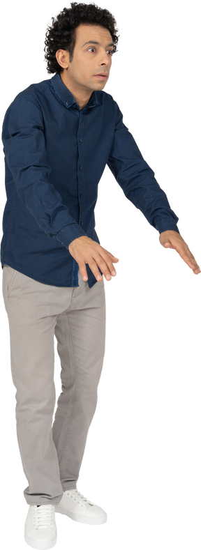 Front view of a man in casual clothes standing with outstretched arms