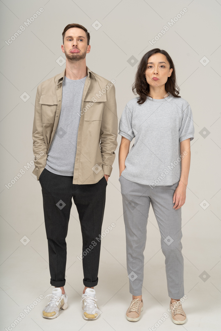 Front view of young couple pouting