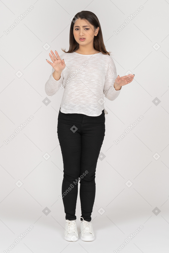 Front view of a gesticulating young indian female in casual clothes explaining something