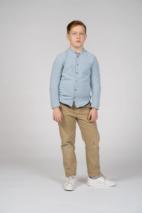 Front view of a cute boy in casual clothes looking at camera