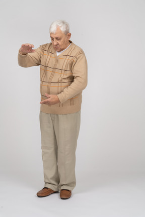 Front view of an old man showing size of something