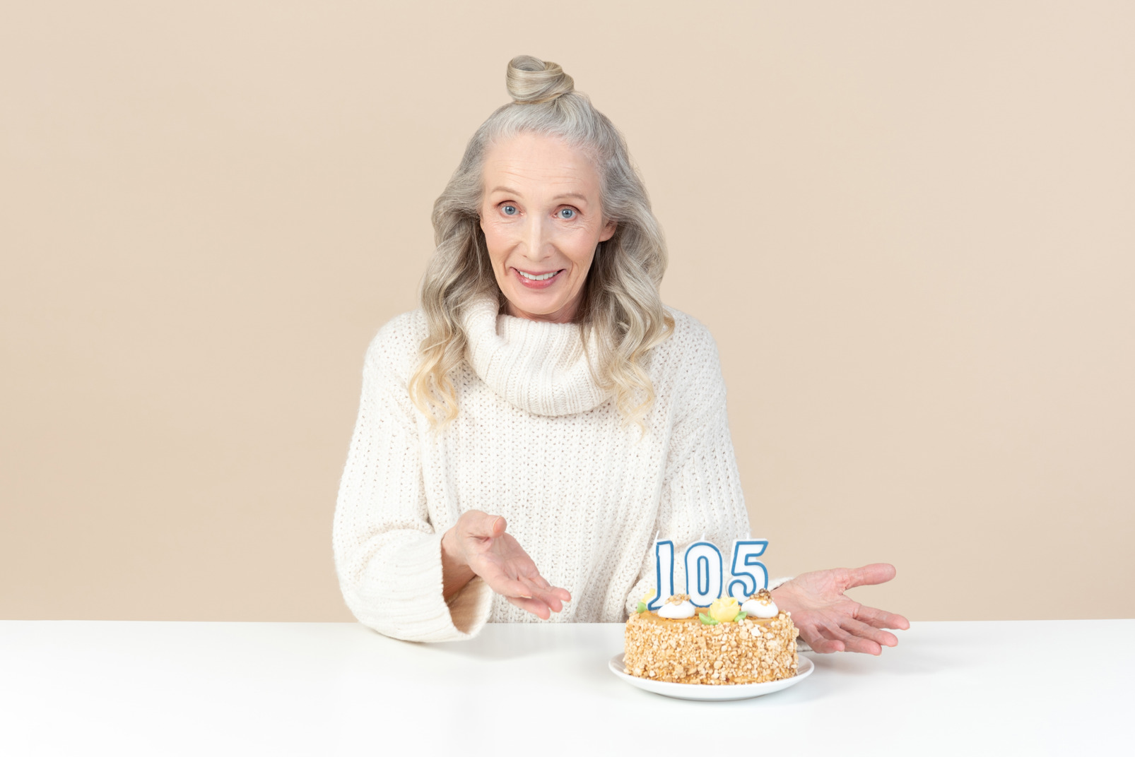 Old woman pointing on cake to her hundred and fifth birthday