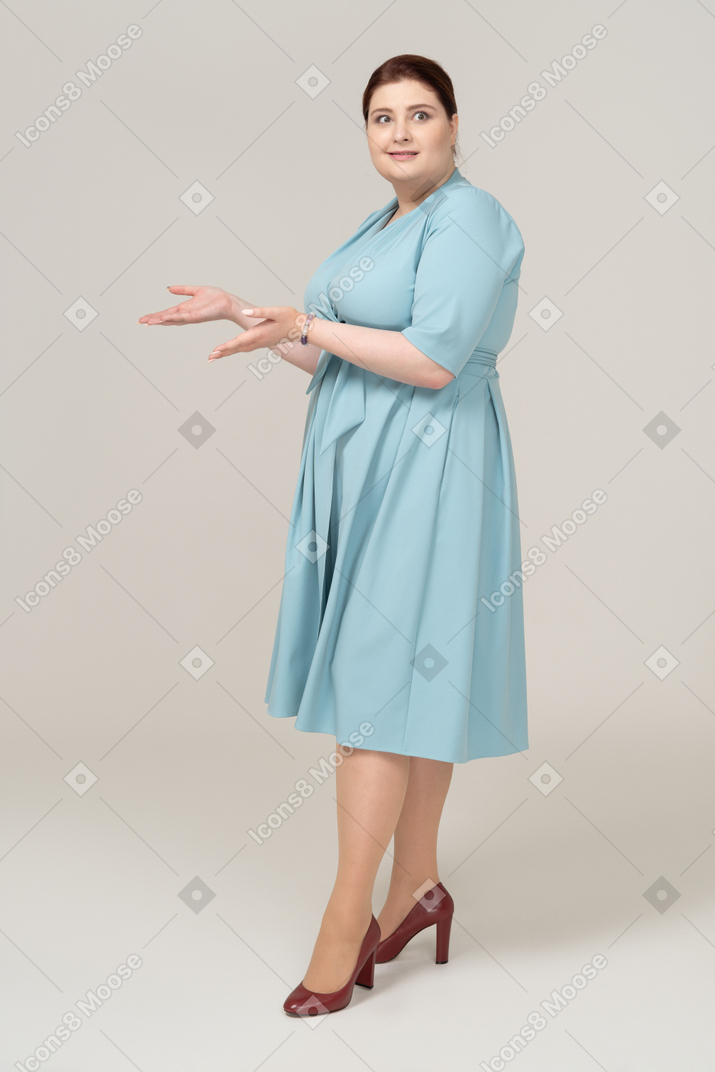 Front view of an impressed woman in blue dress