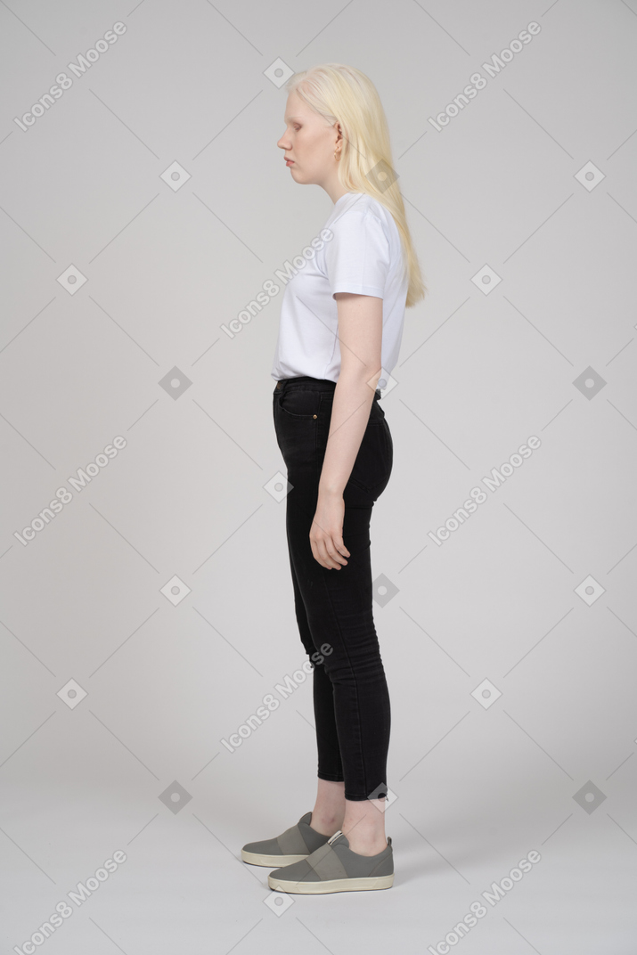 Profile view of a woman in casual clothes looking down