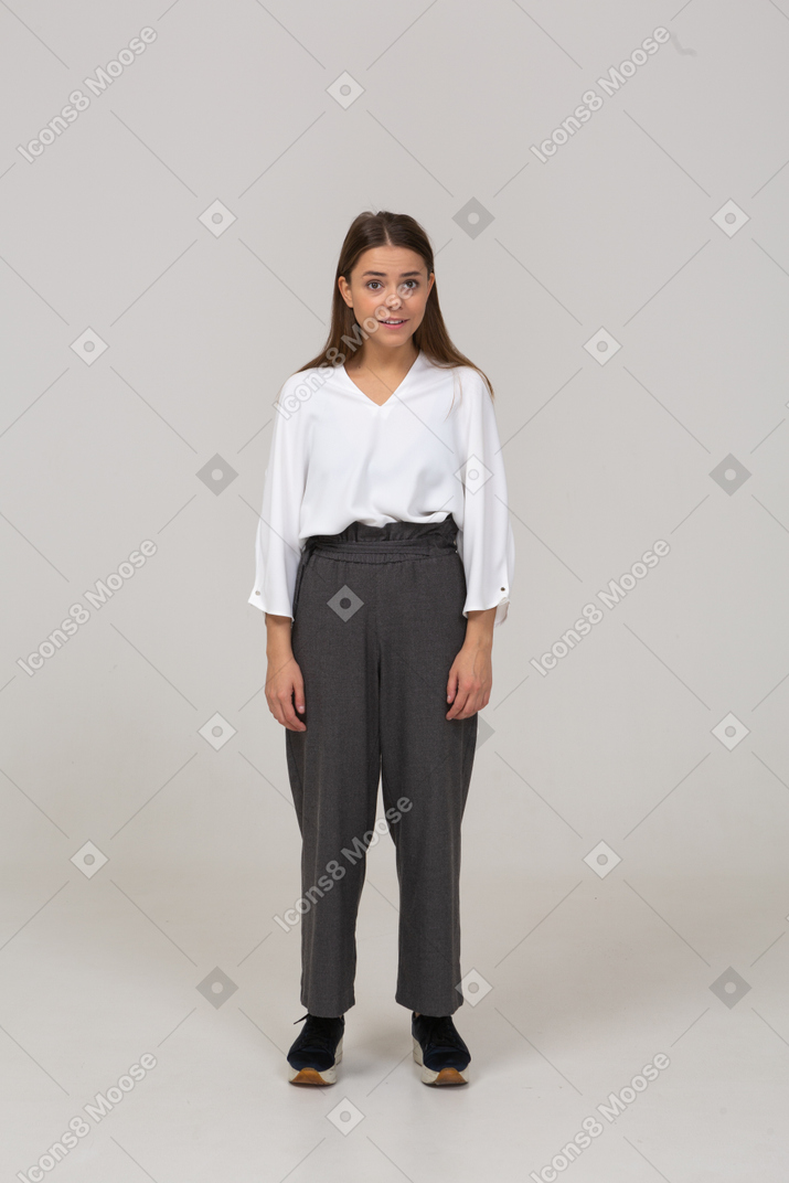 Front view of a young lady in office clothing looking at camera