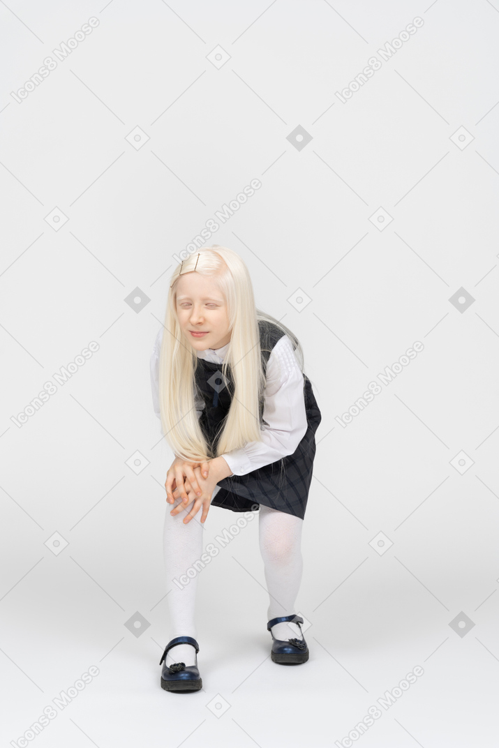 Schoolgirl touching her hurt knee