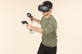 Young caucasian guy playing a virtual reality game