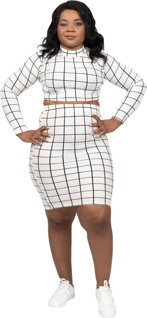 Front view of a beautiful young lady standing with hands on hips