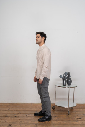 Man in casual clothes standing in profile