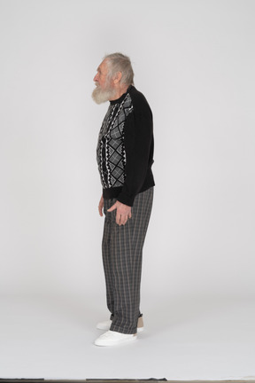 Side view of elderly man standing with arms at side