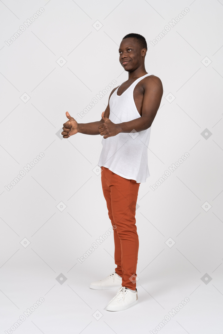 Young black man looking aside and showing thumbs up