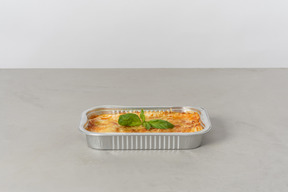 Piece of lasagna in oven pan