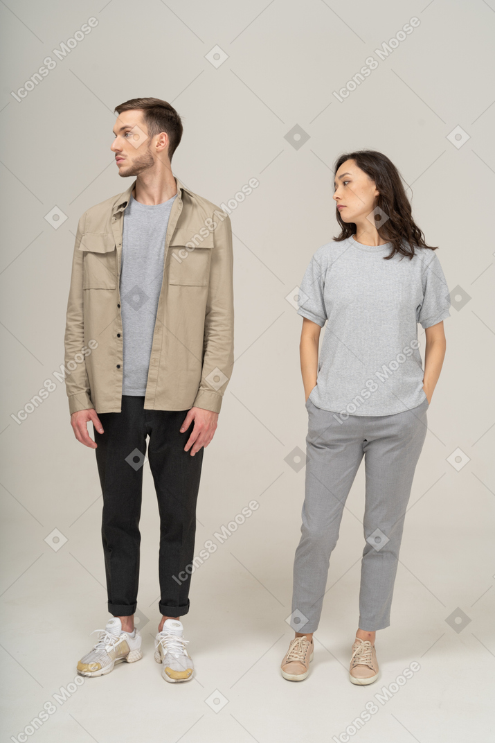 Young couple looking over shoulders