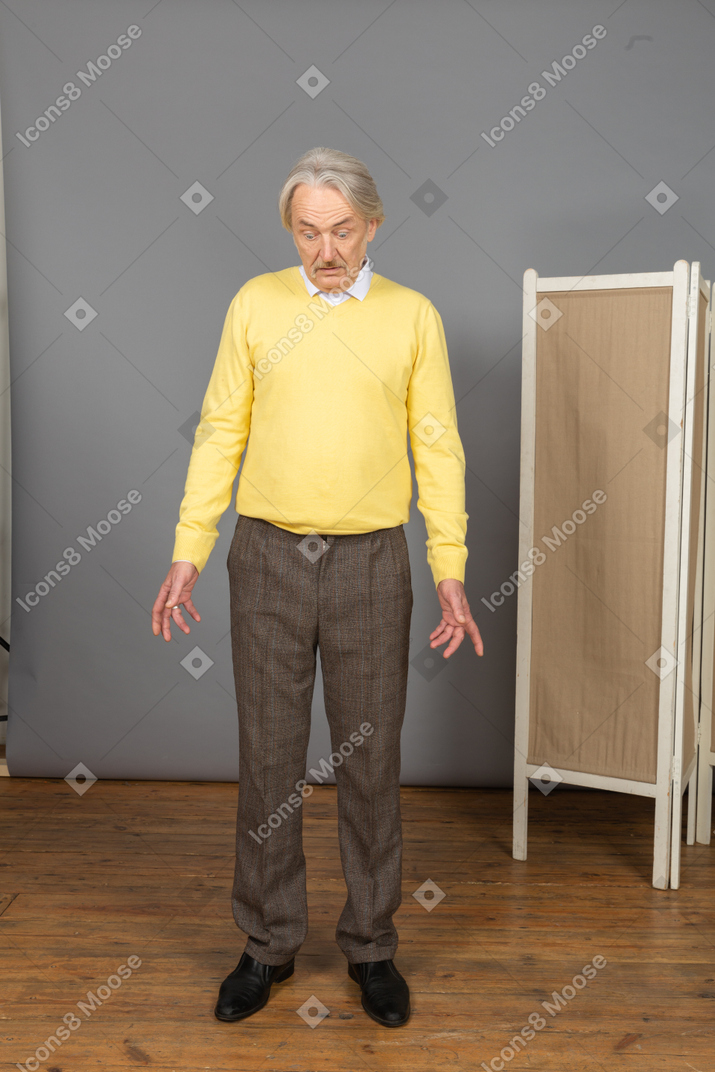 Vista frontale di un uomo anziano interrogante che distende le mani