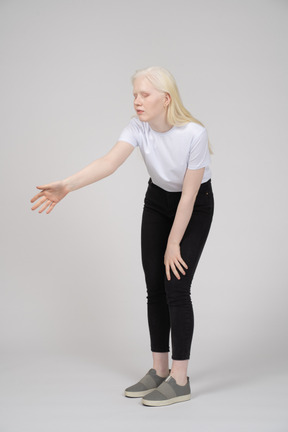 Young woman reaching her arm out