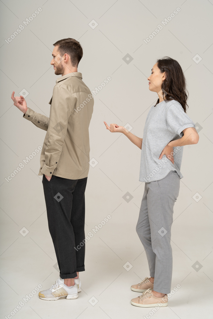 Side view of young couple luring with finger