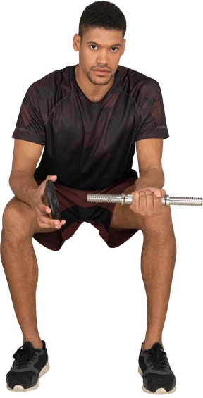 Young man in sports clothes sitting