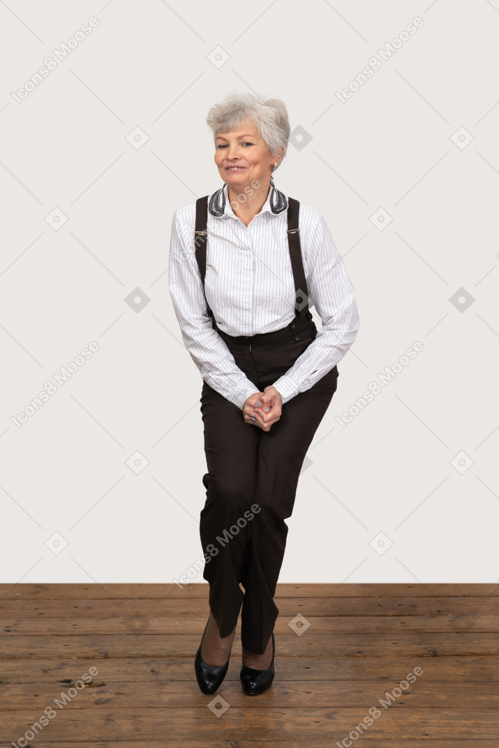 Awkward businesswoman standing with legs pressed together