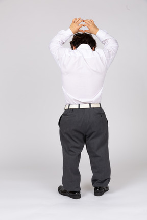 Back view of a young office worker showing a hand heart