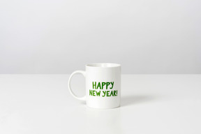 White cup with happy new year sign on it
