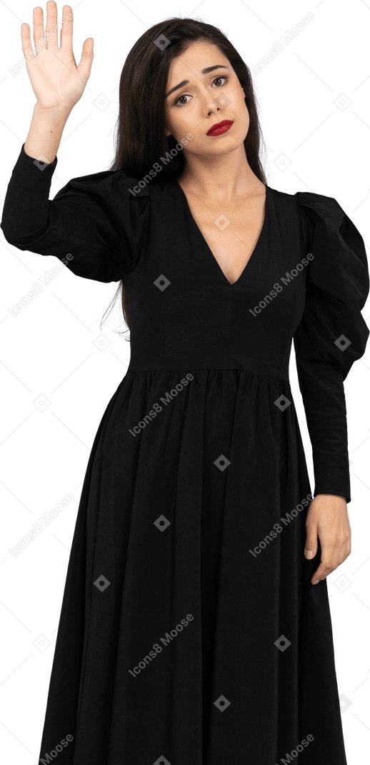 Front view of a sad greeting young lady in a black dress