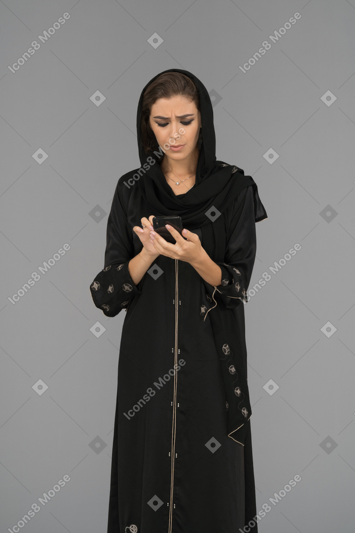 Young arab woman busy in  phone chatting