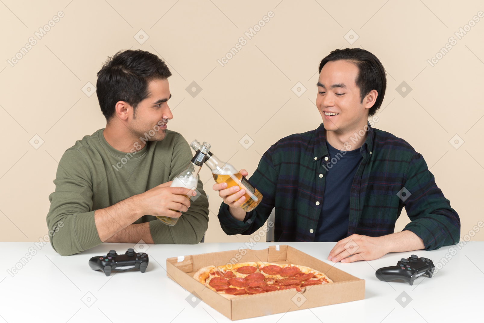Interracial friends playing video games and doing cheers with beer