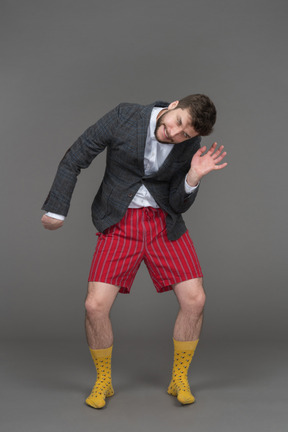 Young man in red shorts fooling around