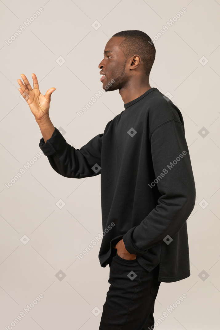 Side view of black man gesturing with hand