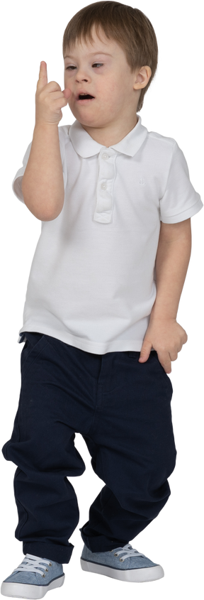 Front view of a boy looking at his finger