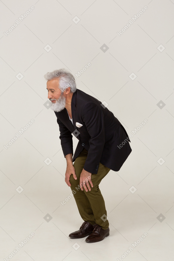 Man in a jacket leaning on his knees
