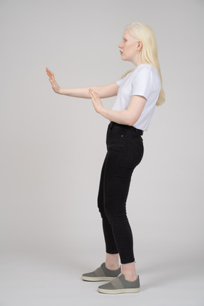 Side view of a young lady stretching her arms