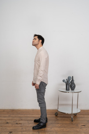 Man in casual clothes standing in profile