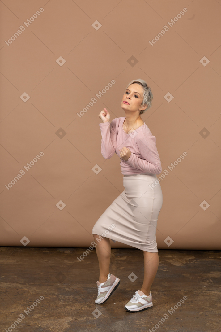 Side view of a woman in casual clothes dancing