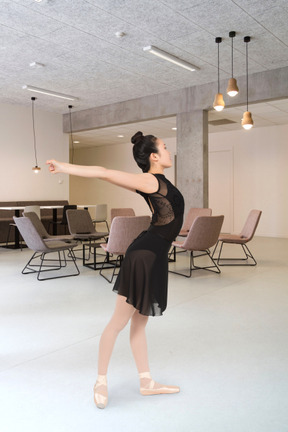 A woman ballet dancing in a conference room
