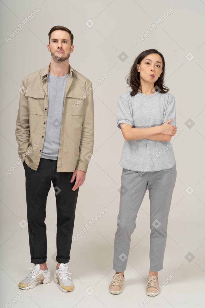 Front view of young couple pouting