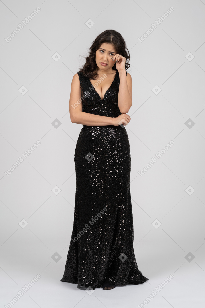 Upset woman wearing black evening dress