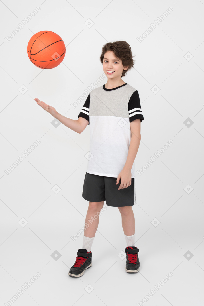 Boy throwing a basketball ball up