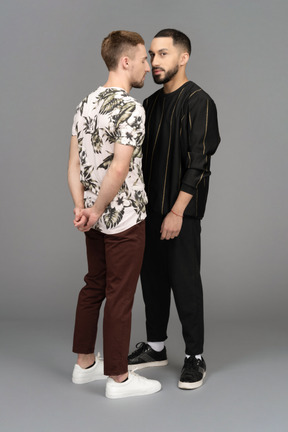 Two young men standing nose to nose