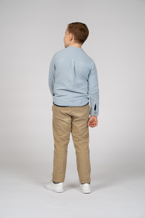 Rear view of a boy looking aside