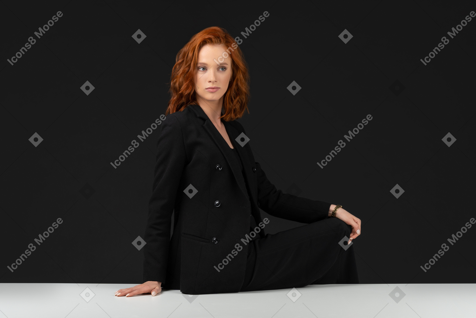 Cute red haired girl sitting on the table