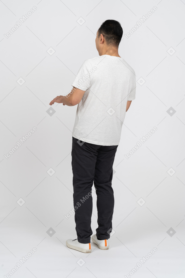 Man in casual clothes standing back to camera and gesturing