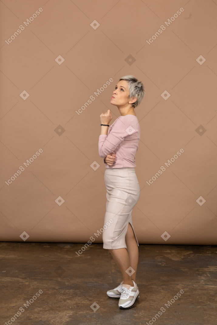 Thoughtful woman in casual clothes standing in profile