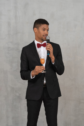 Young man giving a toast and looking aside