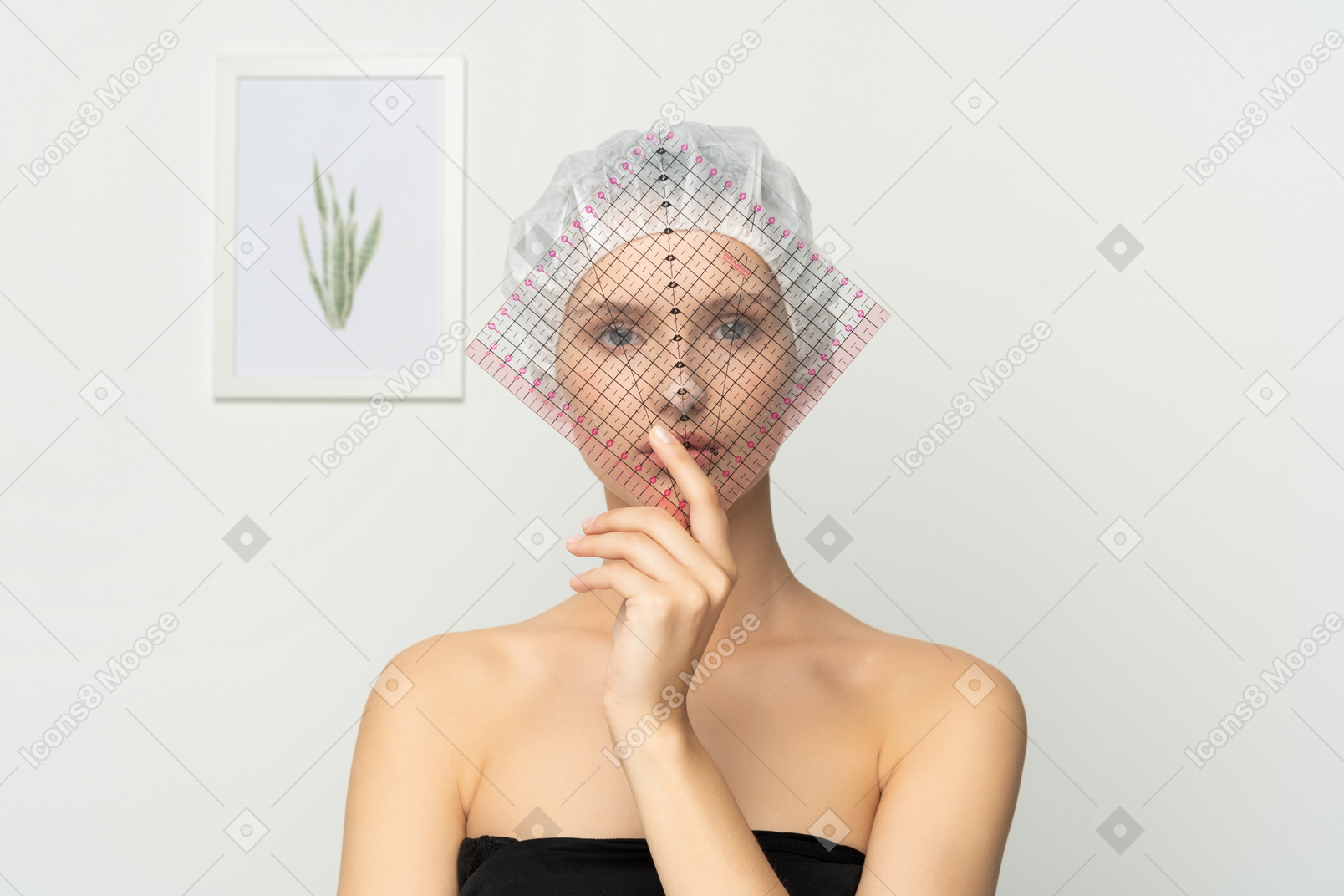 Young woman holding a plastic grid over her face