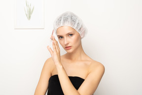 Young woman holding syringe while looking at camera