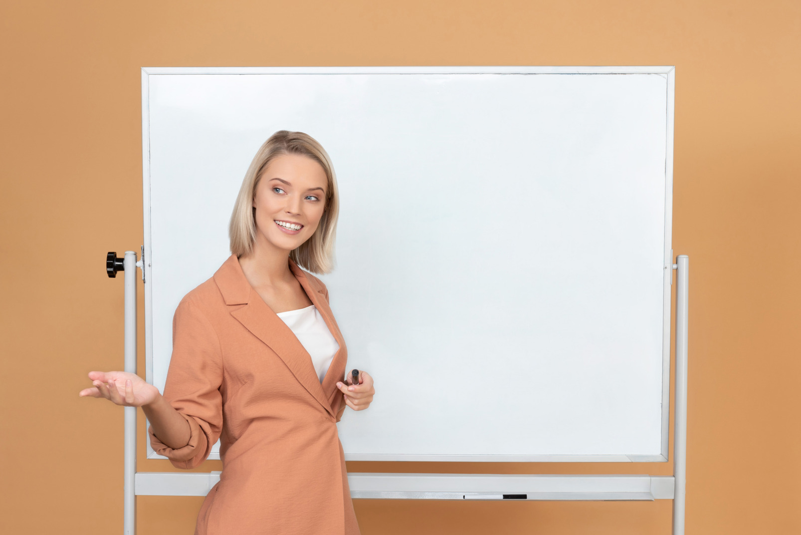 Attractive young woman explaining something near the whiteboard