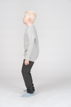 Side view of a boy with bent knees