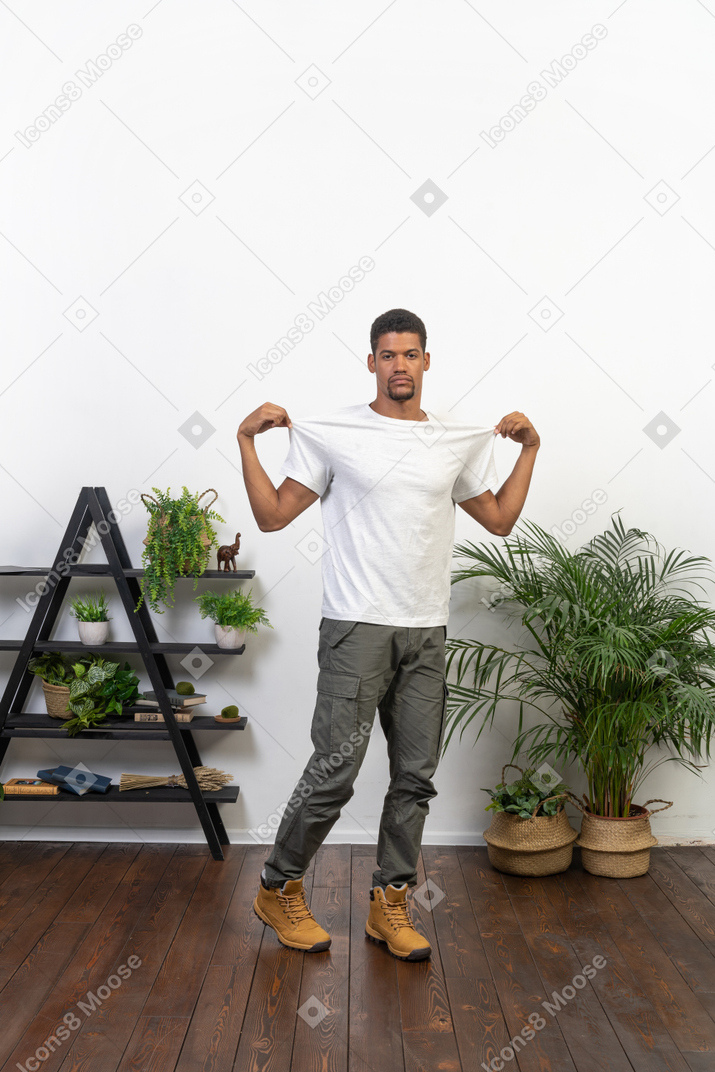 Handsome athletic man posing on the background of the apartment
